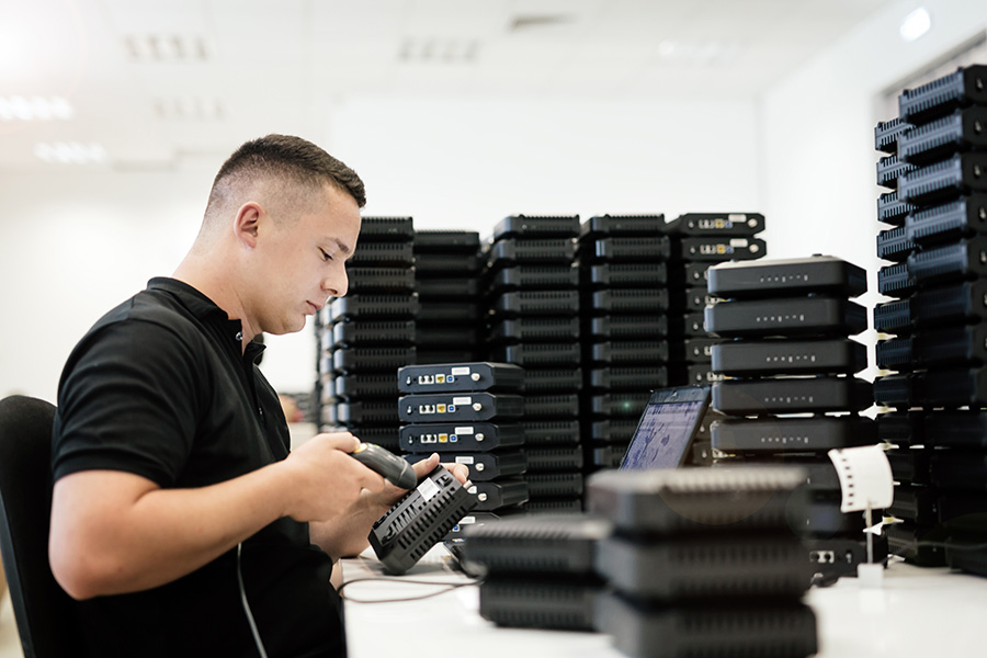 Worker using barcode reader Boxbuild